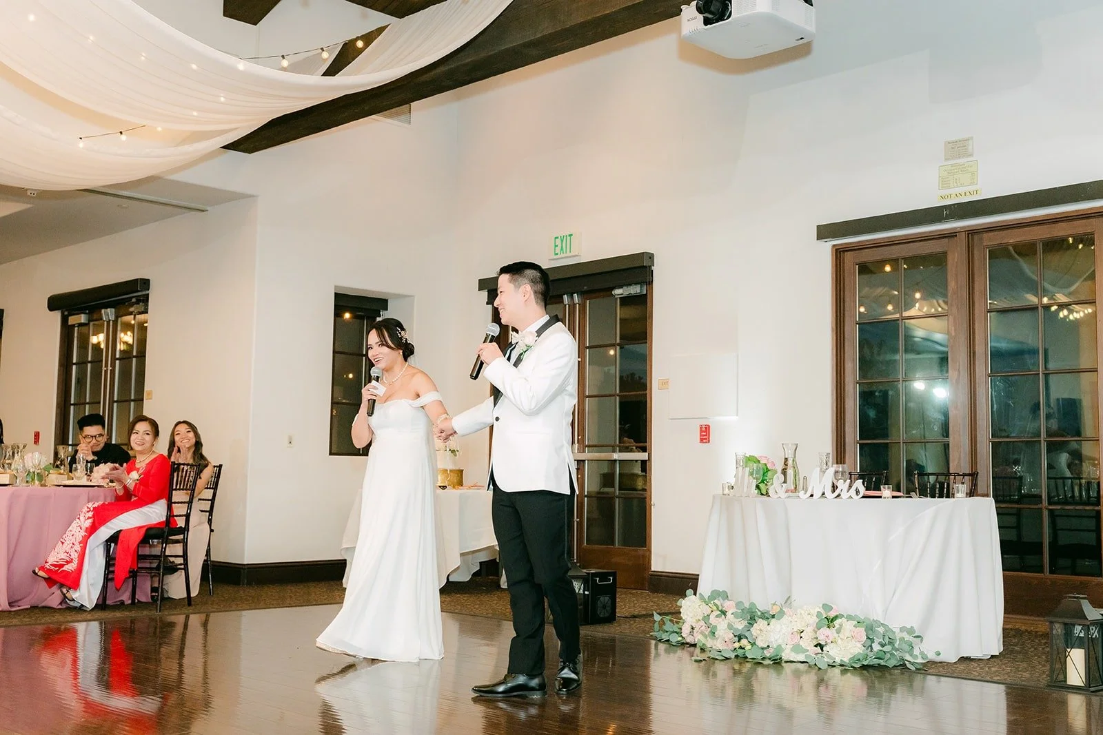 Ivy and Chungman on the dance floor with sunglasses and props