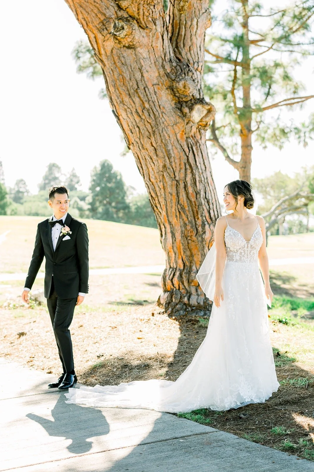 Josephine and David holding hands under the trees, photographed by One and Only Production