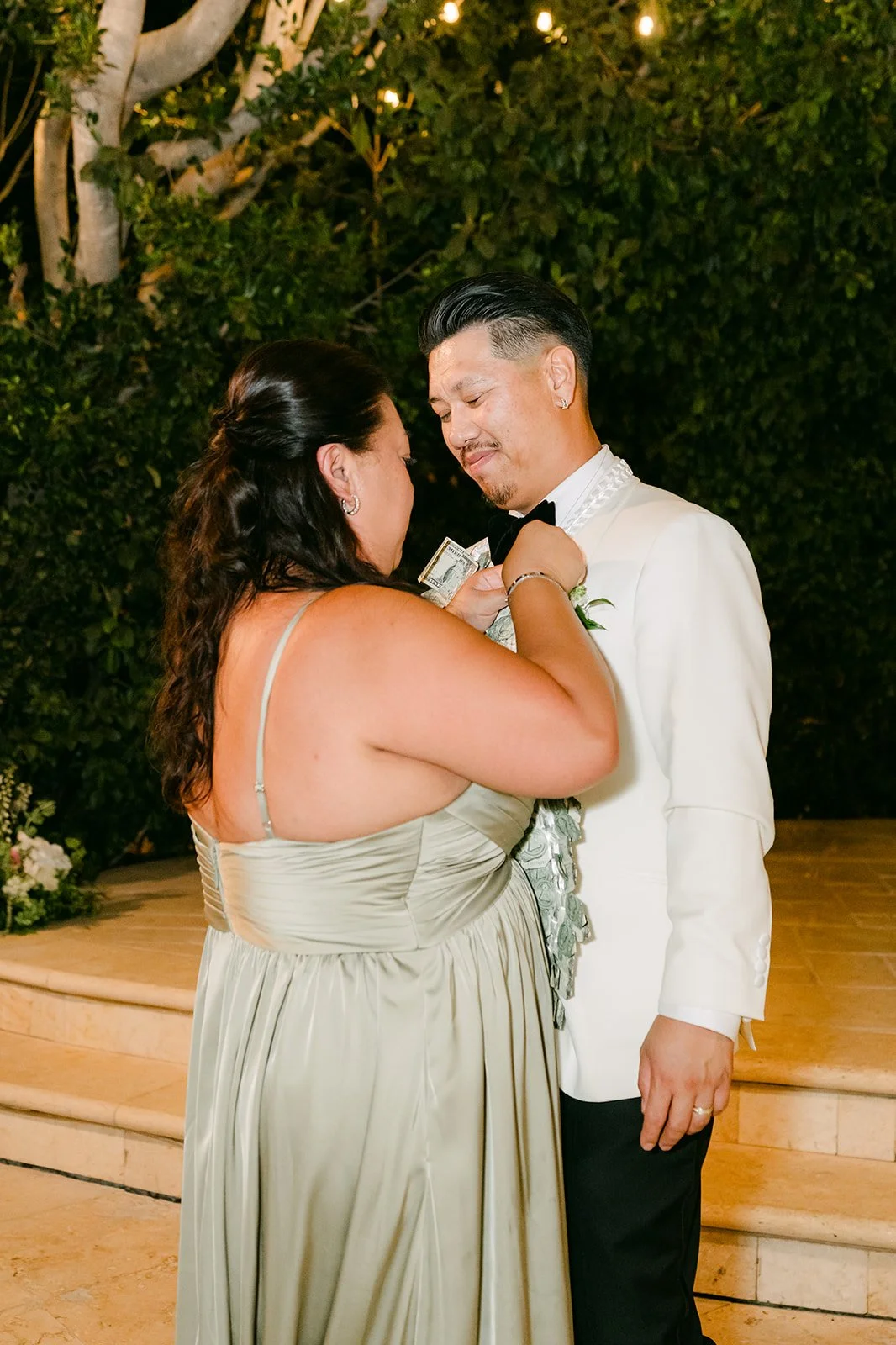 Caryl dancing with a bridesmaid during the money dance.