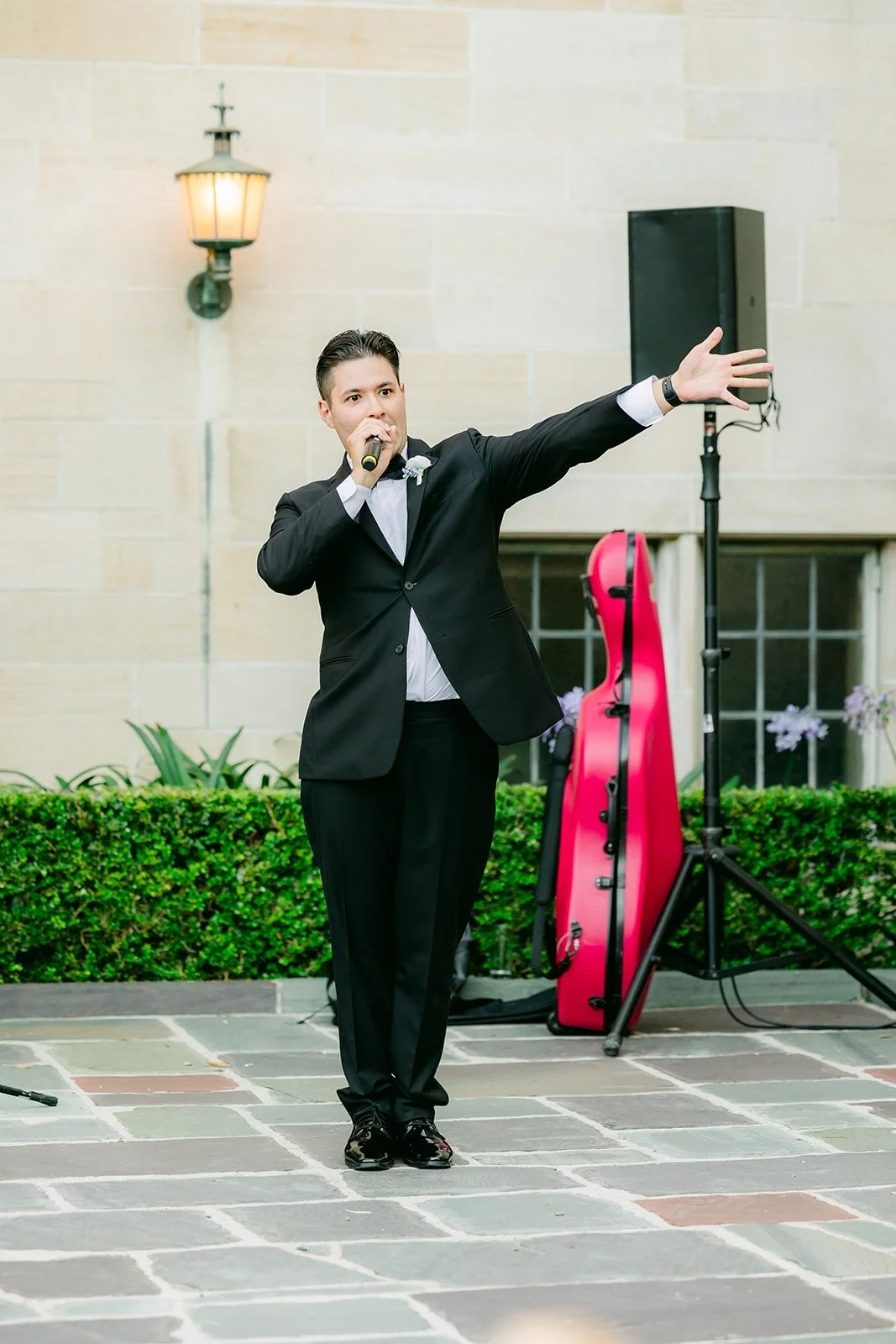 The emcee introducing the wedding party in the courtyard