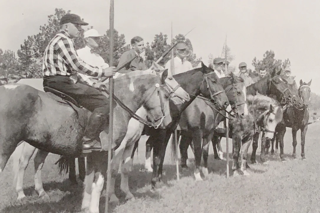 At the 1952 tri-centennial celebration, horsemen line up for the tilting tournament. Tilting, otherwise known as riding at the rings or ring spearing, is a form of jousting in which the horseman rides at full gallop and inserts his lance through small metal rings.