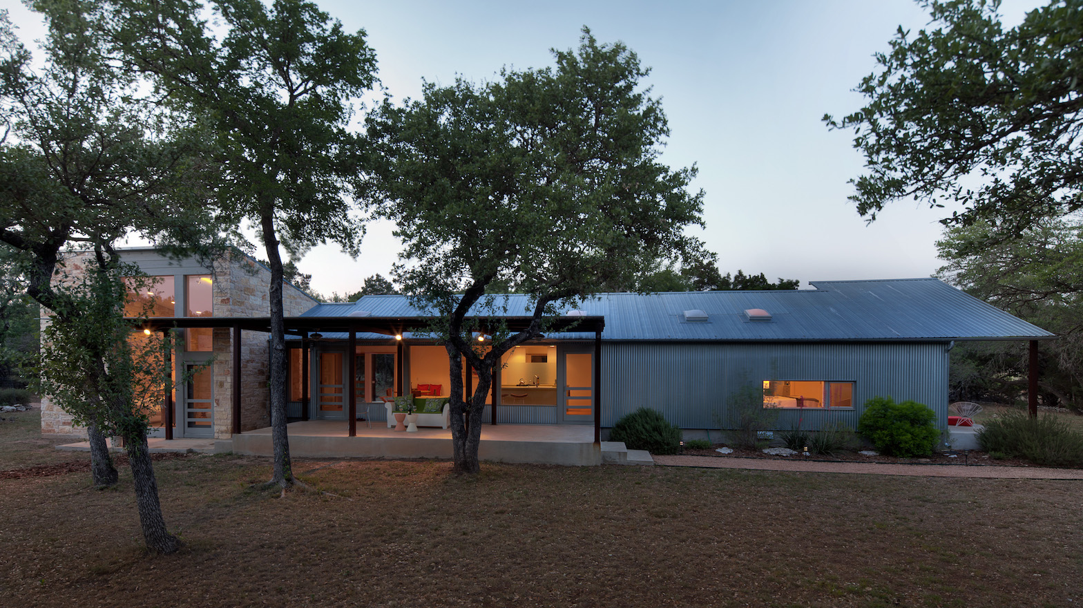 Important aspects of the new complex are a companion works studio, a cool limestone den, and porches facing morning, noon, and night.