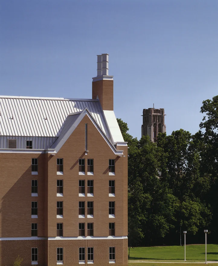 The dormitory is given steep roofs and Neo-Gothic proportions in order that it seem connected to the old structures, but its special use of anodized aluminum makes it stand out. The sharply carved details change in light and shadow reminiscent of the high relief stone profiles of the traditional collegiate Gothic buildings.