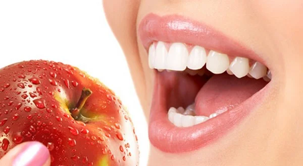 smiling-teeth-biting-apple.jpeg