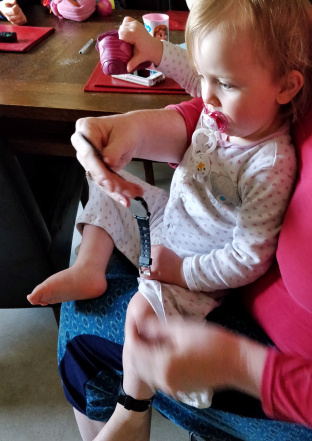 Research Assistant Charlotte inspecting the actigraph before giving it her seal of approval
