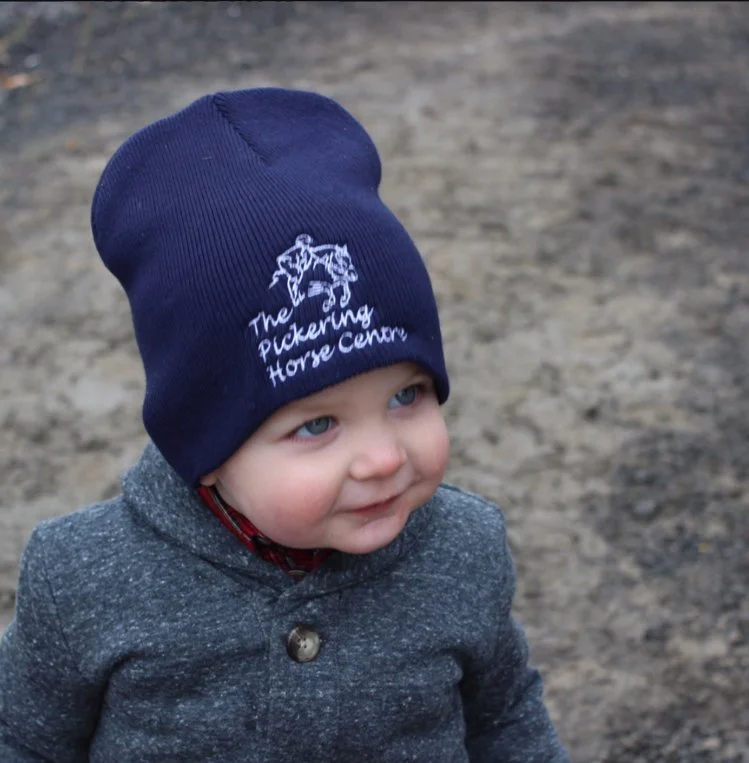 A young equestrian wearing a Pickering Horse Centre branded toque