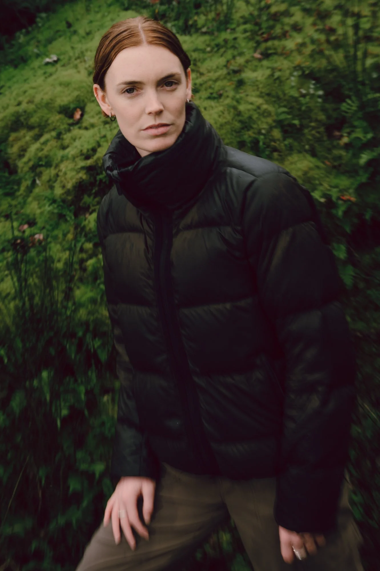 Portrait of a model wearing outdoor apparel in a dense forest on Vancouver Island, suited for an Arc'teryx lifestyle campaign