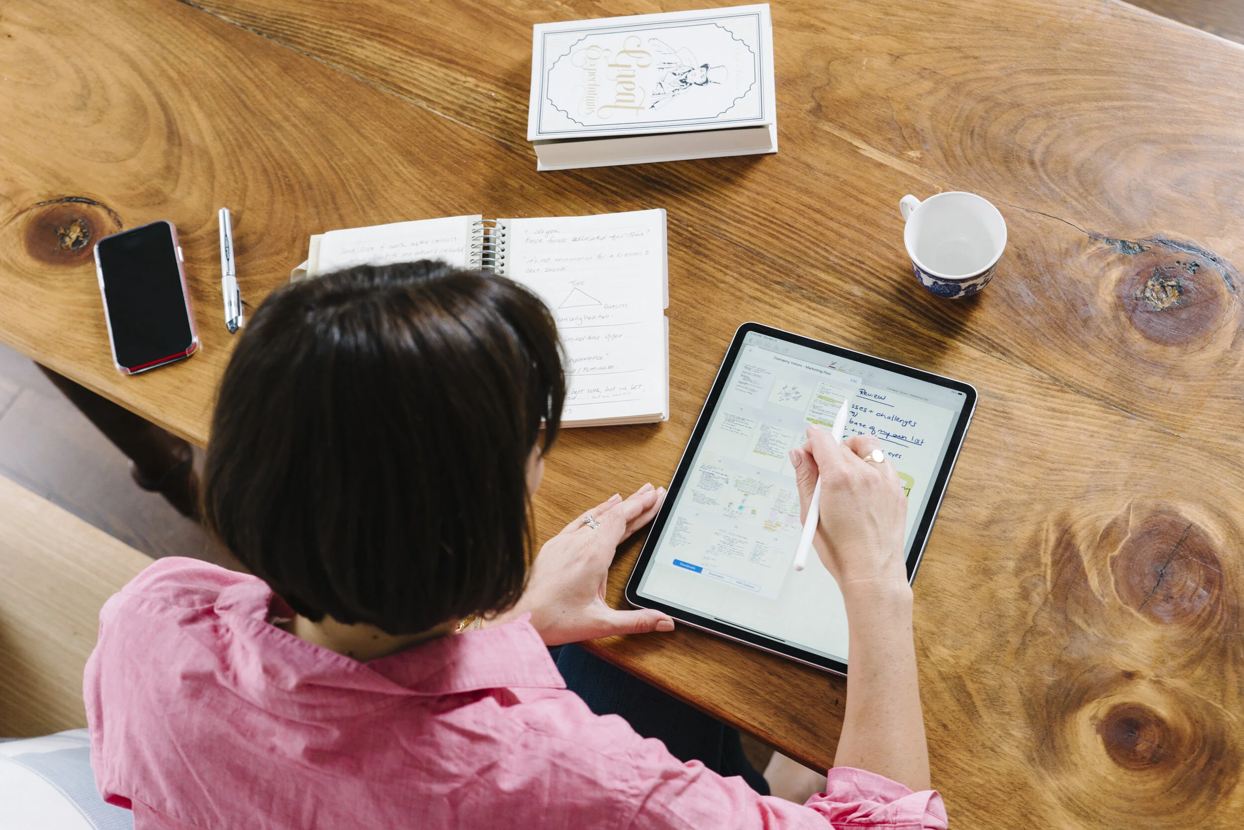 Overhead lifestyle photo of interior designer Rebecca Hay working on her iPad