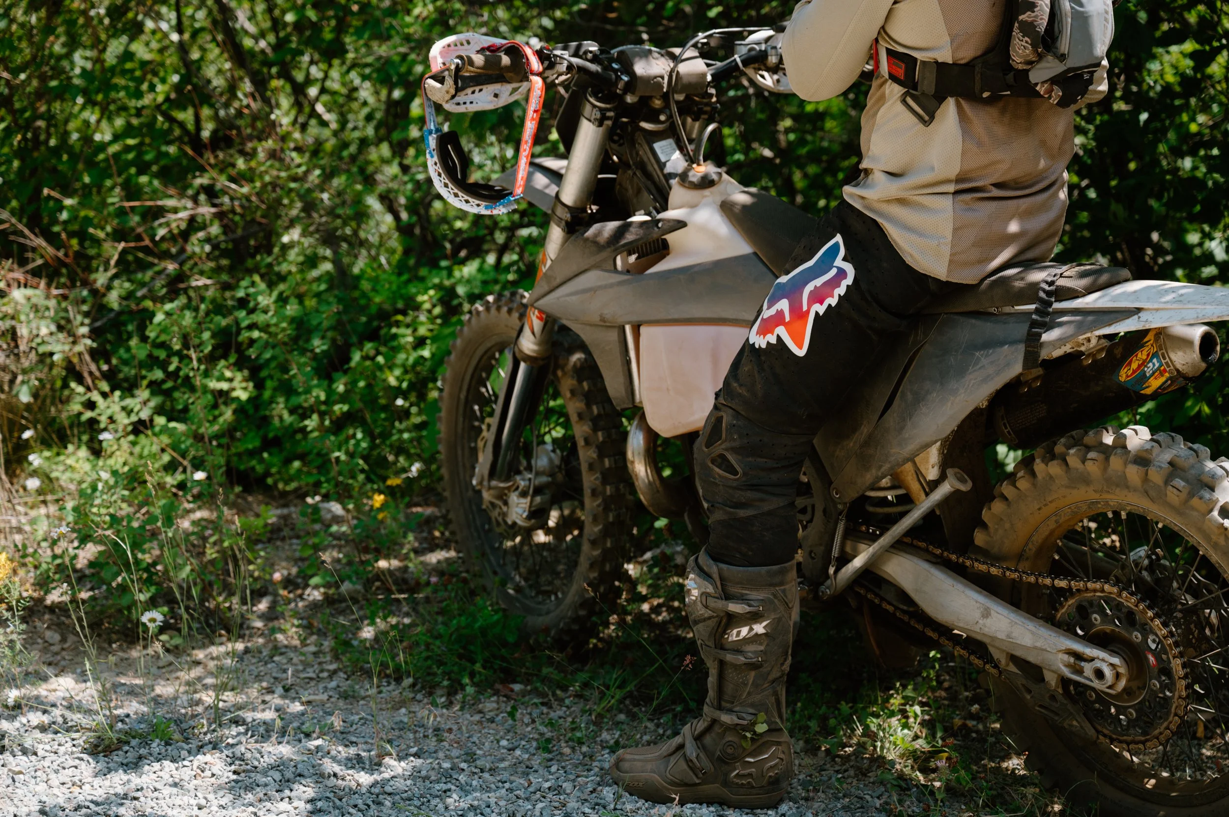 Close detail photo of Fox Racing logo on a dirt bike rider's pants and gear, shot on location in BC