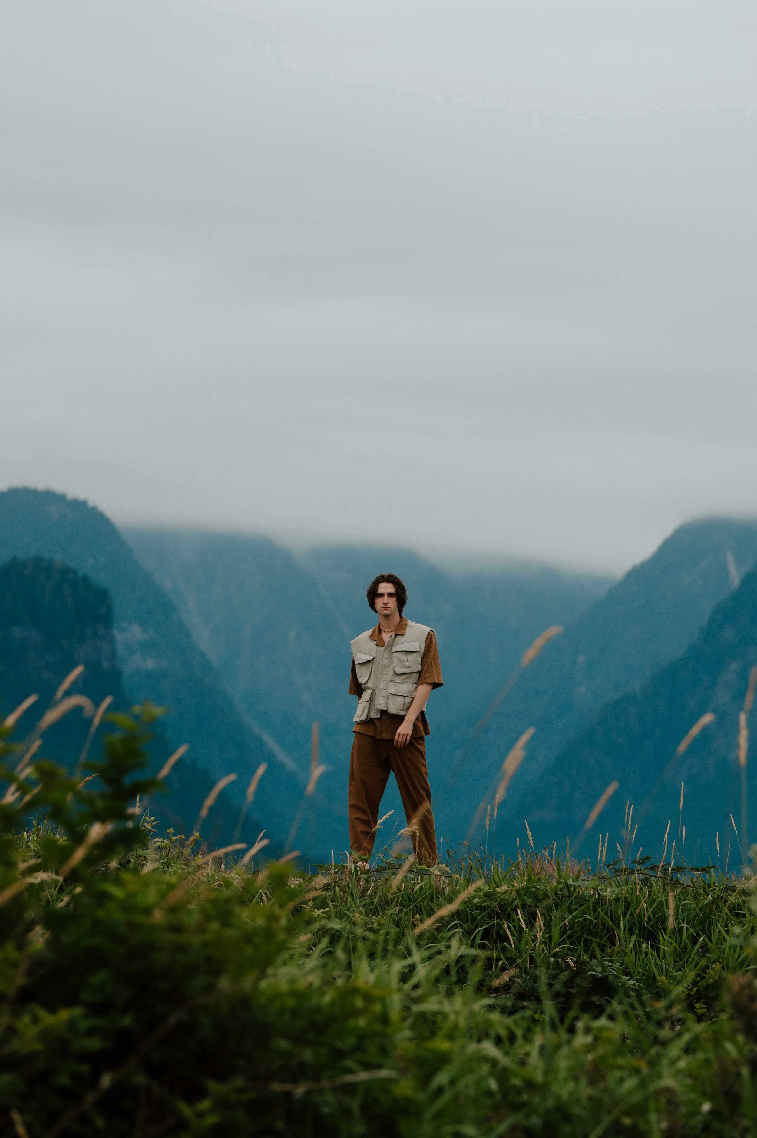 Callum Campbell posing against mountainous terrain in British Columbia for editorial photography