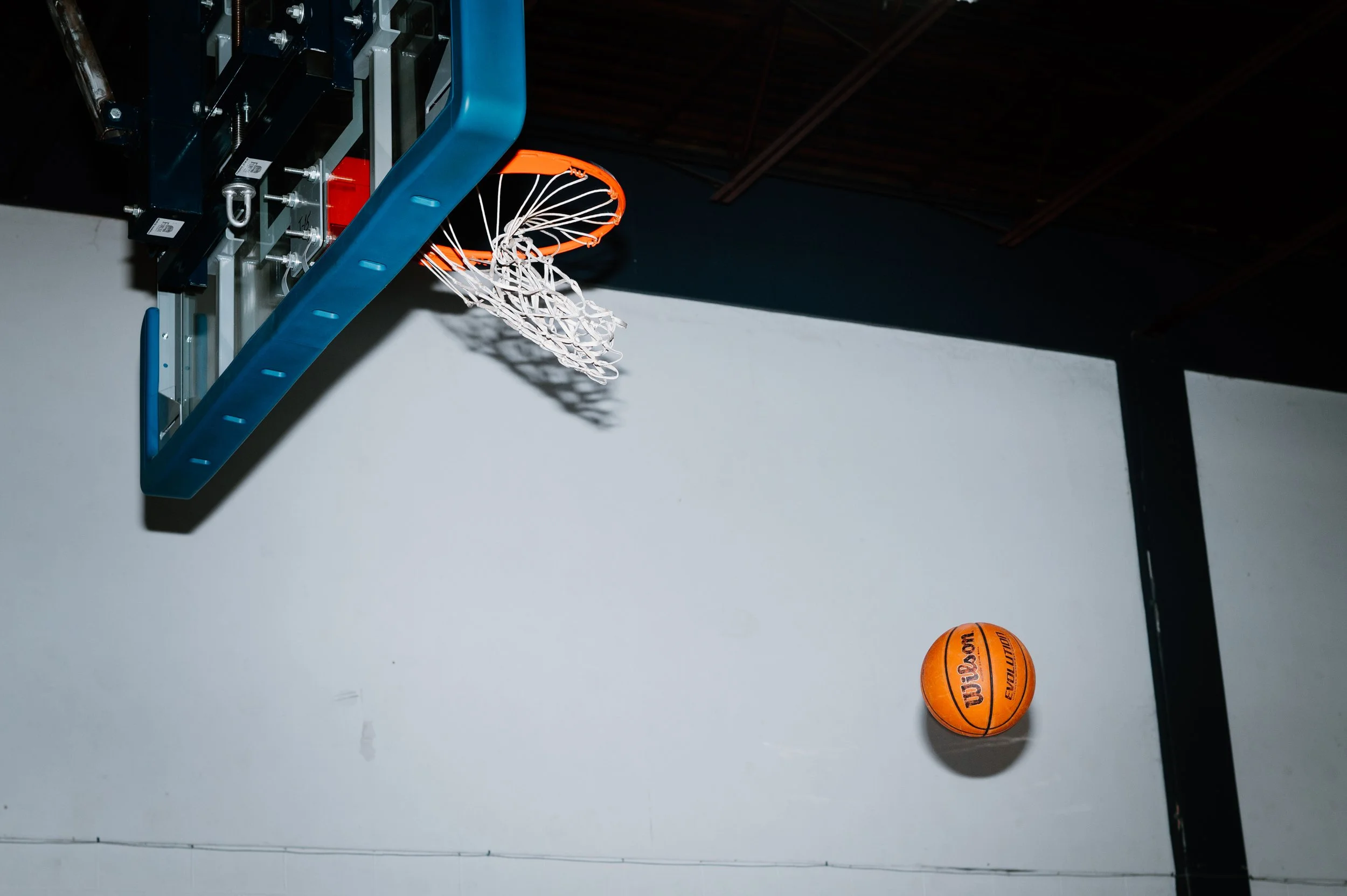 Close editorial detail shot of a basketball dropping through the net during Marquette University practice