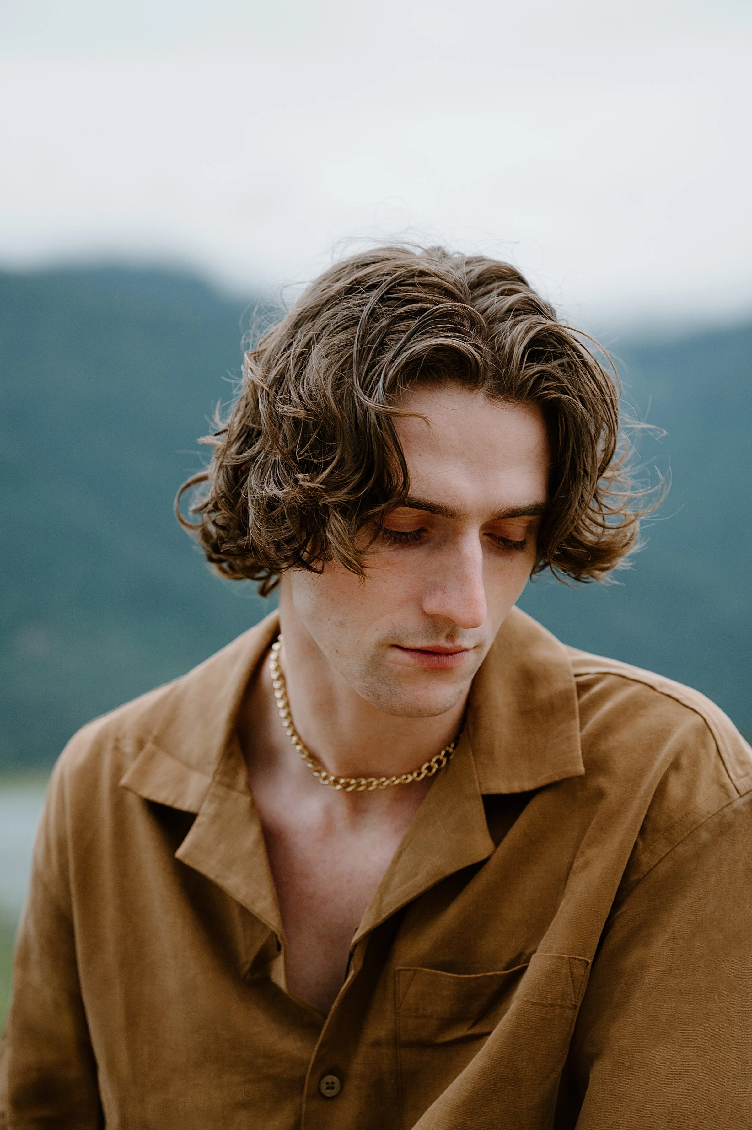 Outdoor portrait of model Callum Campbell in Pitt Meadows, highlighting fashion and landscape