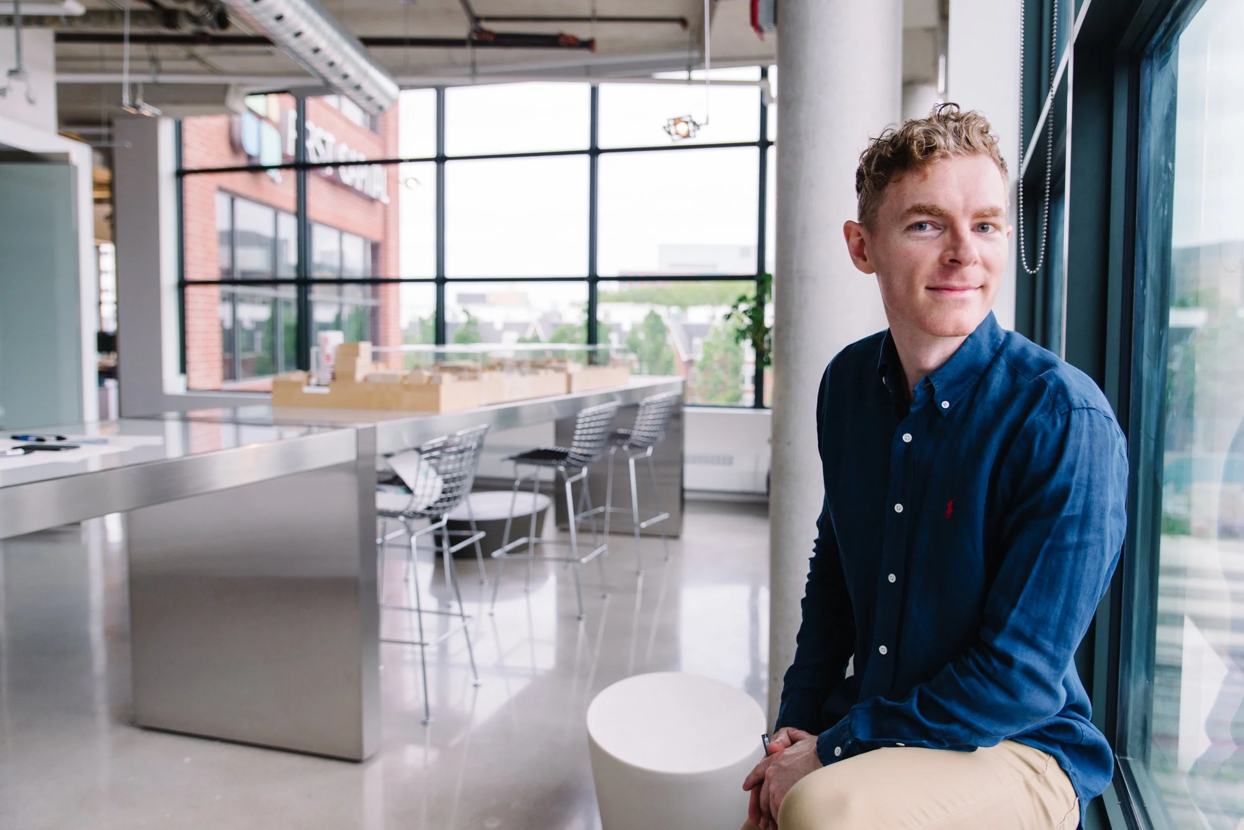 Lifestyle corporate headshot of a Kasian staff member in their Toronto office