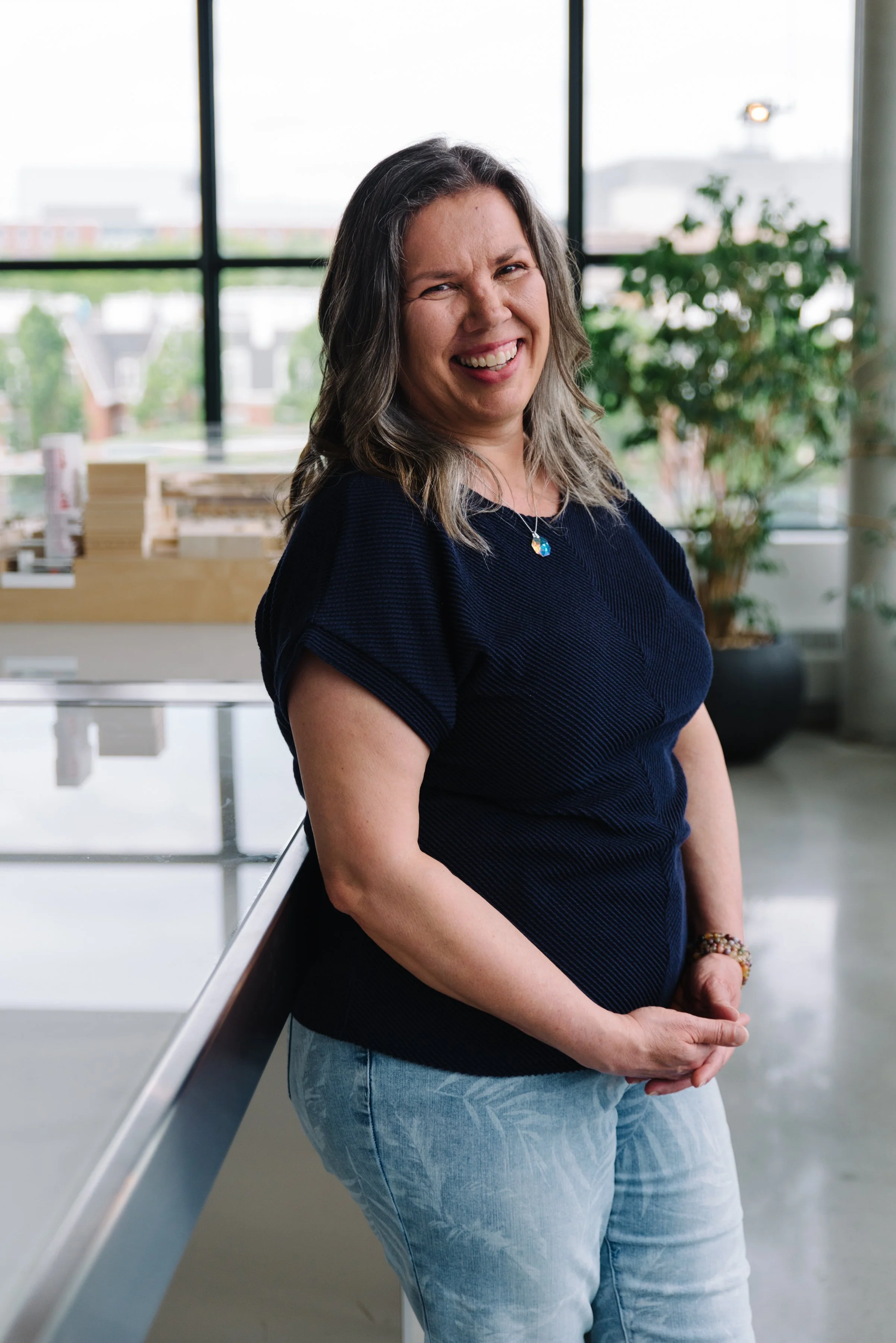 Professional headshot of a Kasian team member using the office interior as a backdrop