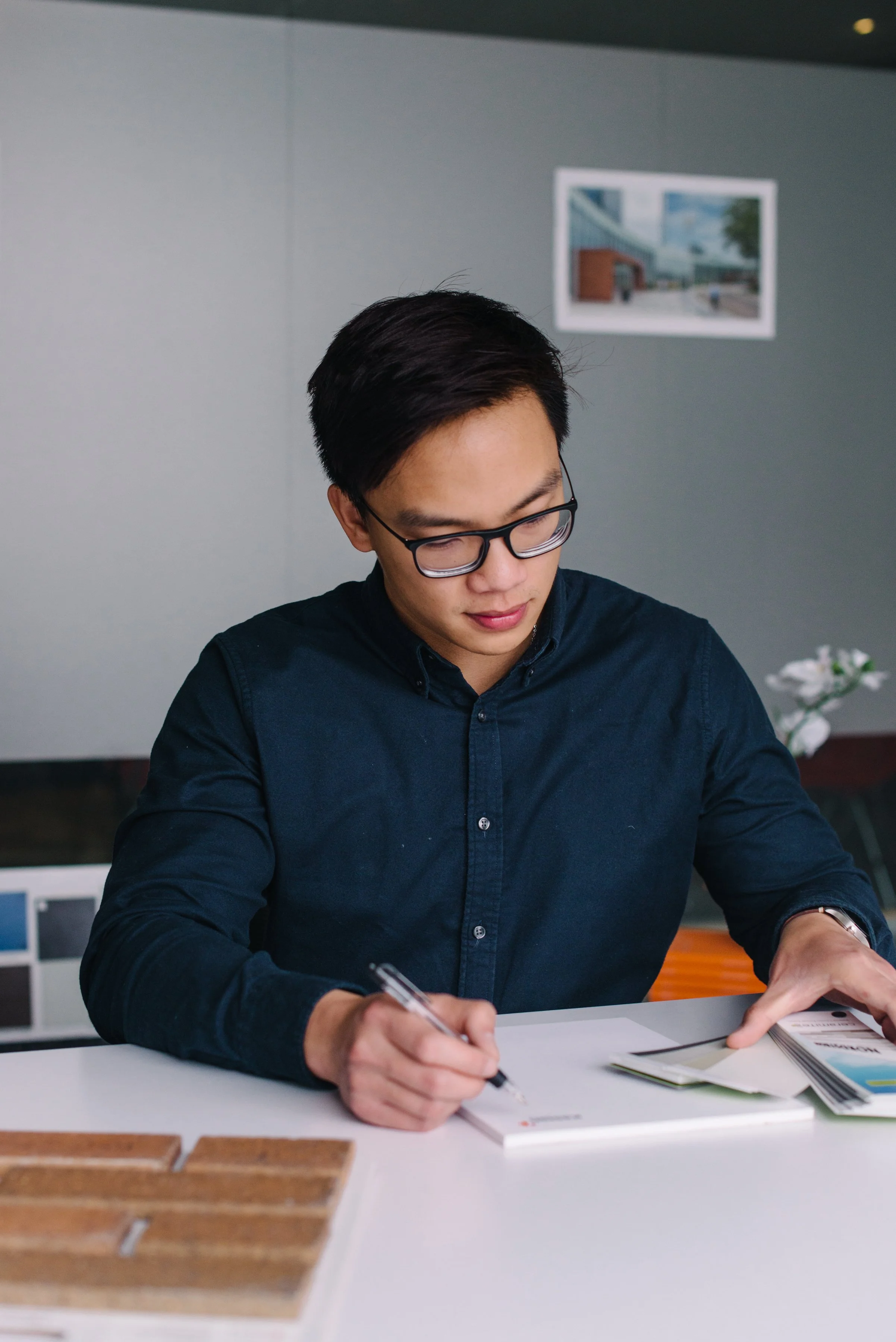 Environmental headshot of a Kasian professional photographed in their Toronto studio