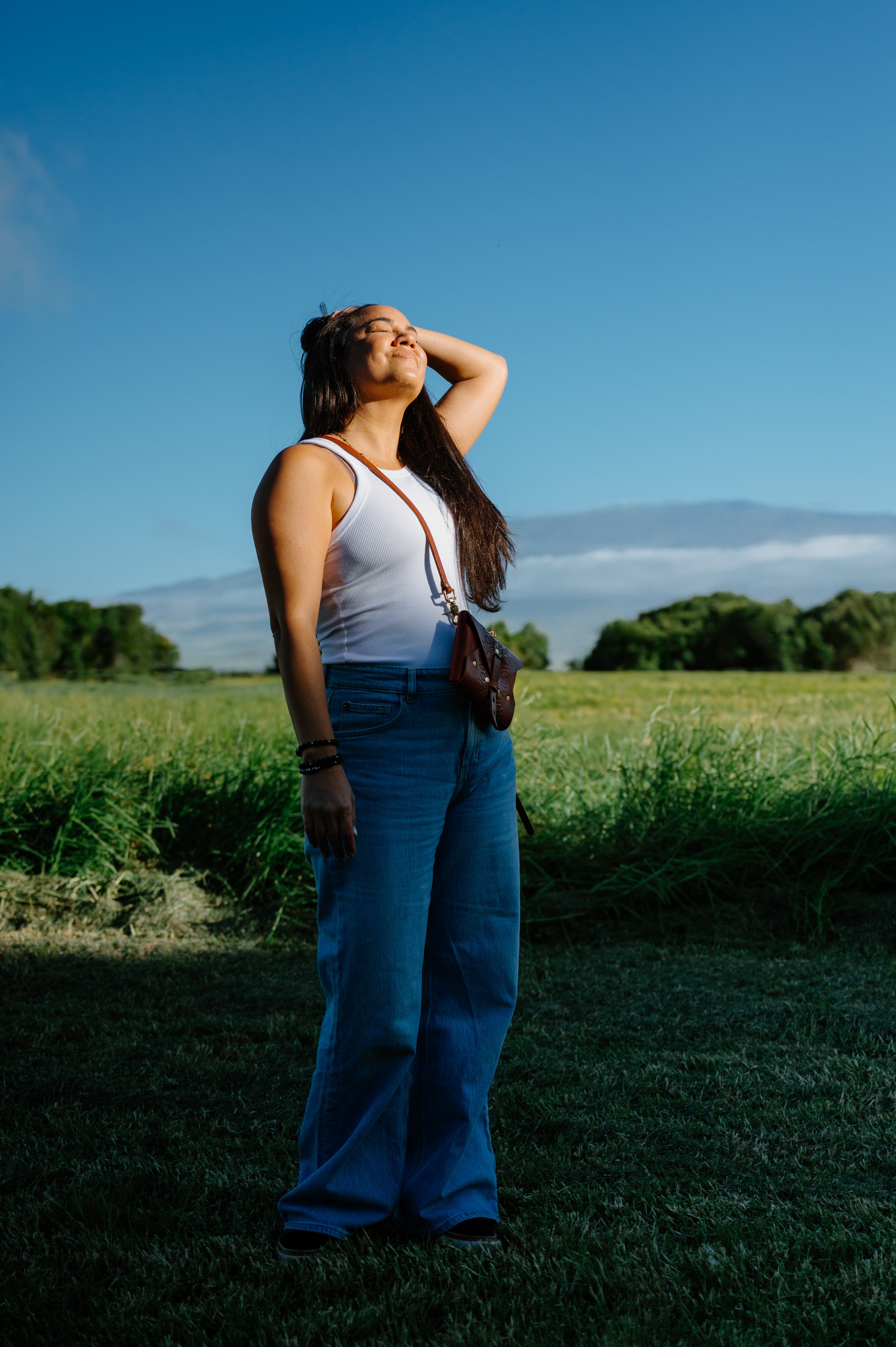 Founder of Salty Western standing in an open field beneath Mauna Kea