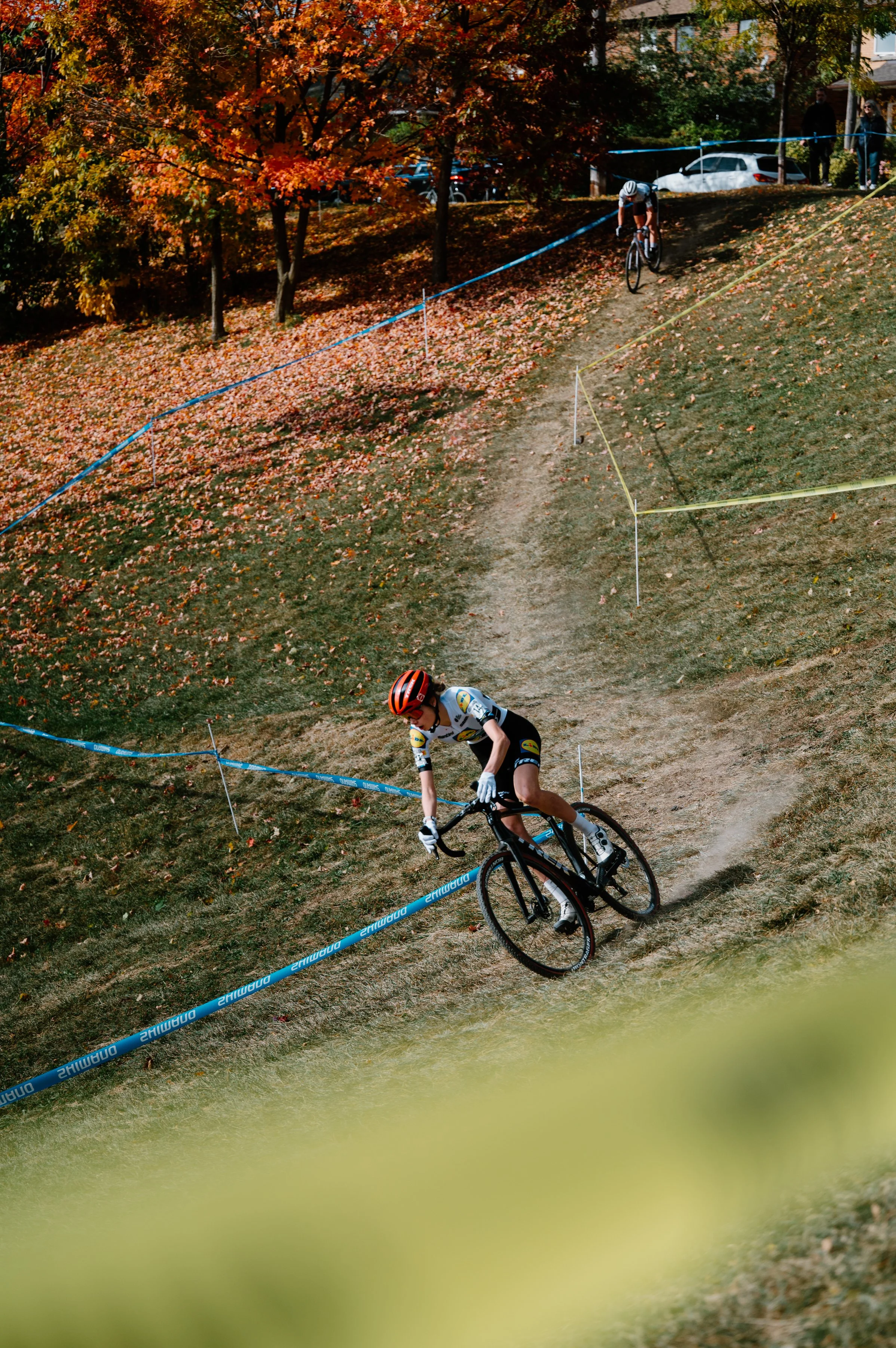 Cyclocross riders descending quickly through Christie Pits Park, suited for a Cervélo cycling brand campaign