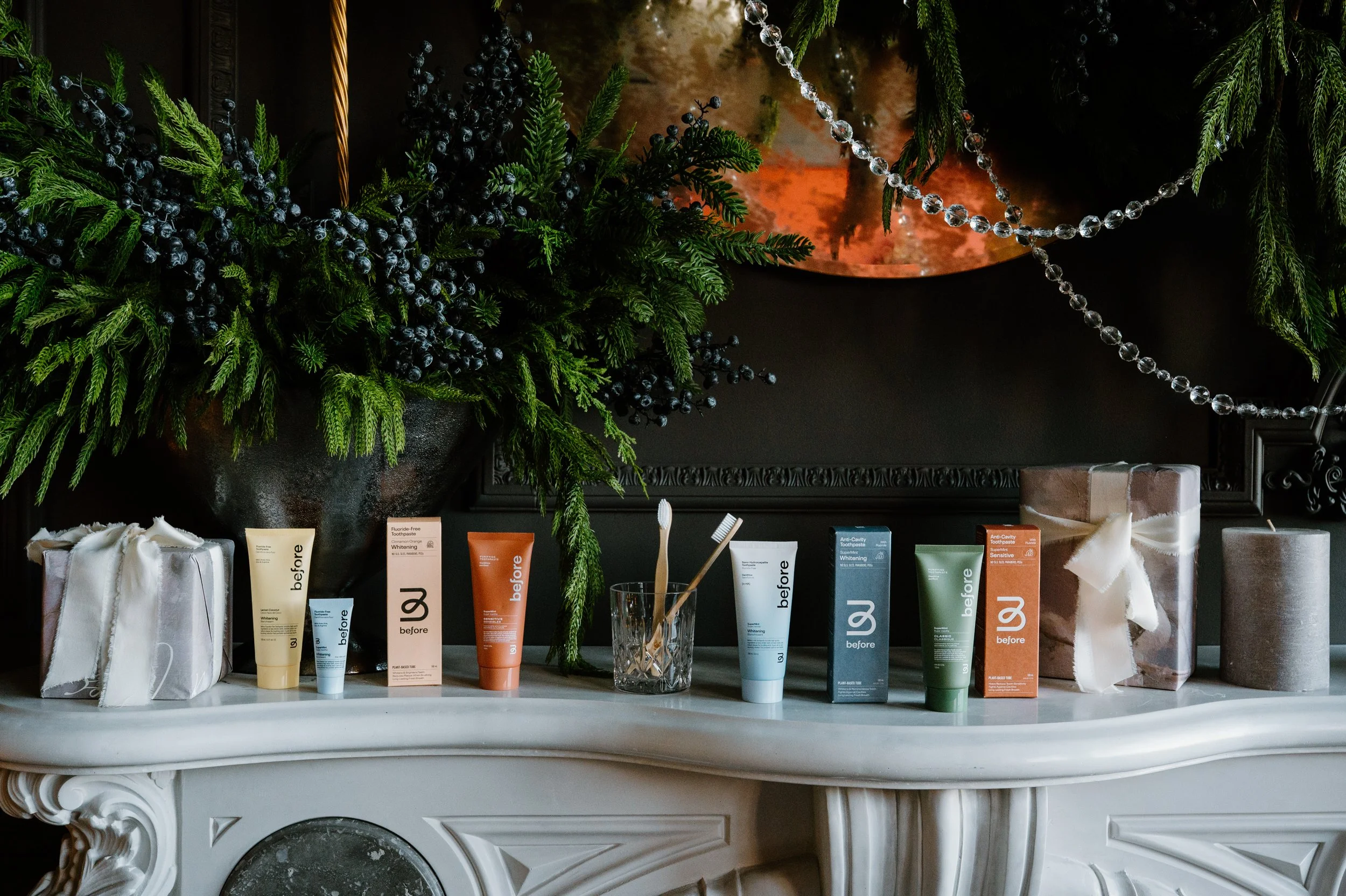 Holiday mantle scene featuring Before products as gifts in seasonal environment