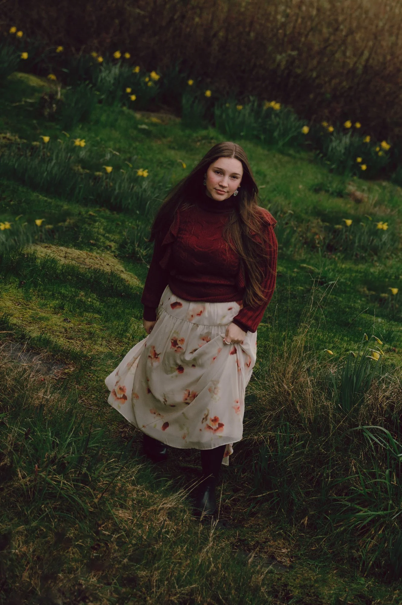 Outdoor model test photo of a model walking toward the camera on a green hillside in Sooke BC