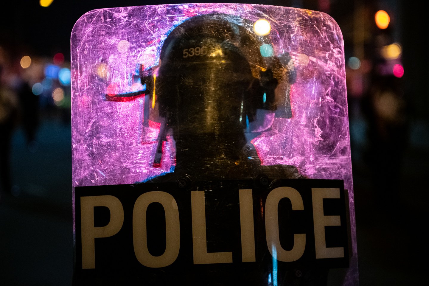  Flashing lights illuminate a police officer’s silhouette on their riot shield after large numbers of police forcefully cleared the area around the MPD Fourth District Headquarters, in Washington, D.C., on October 28, 2020. (Photo by Graeme Sloan) 