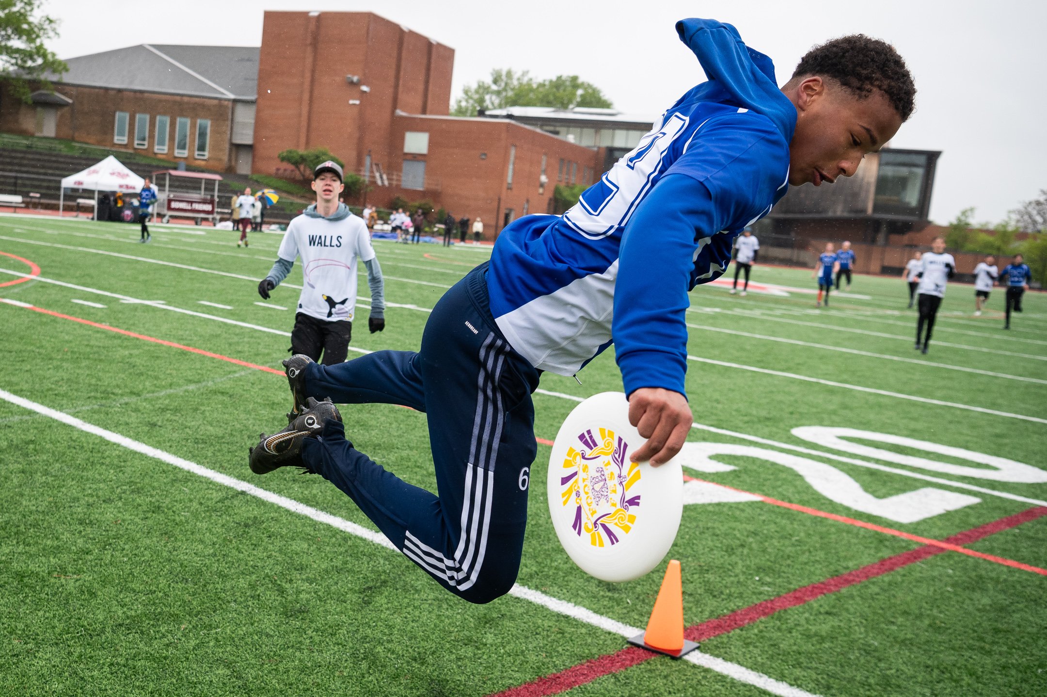  DC International School player Kadin Nuri attempts a diving catch in the end zone, landing just out of bounds in a semi-finals game against the School Without Walls, during the DCSAA High School State Ultimate Championships at Sidwell Friends School