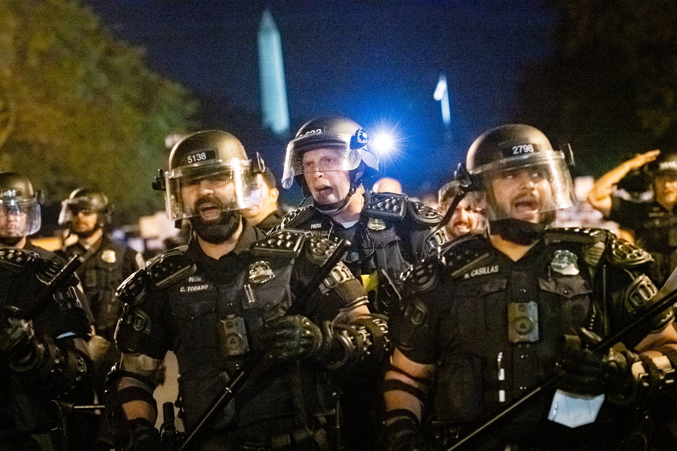 Police officers wearing riot gear use force to clear protesters from Black Lives Matter Plaza late at night, after lengthy demonstrations calling for racial justice and an end to police brutality, in Washington, D.C., on August 29, 2020. (Graeme Slo