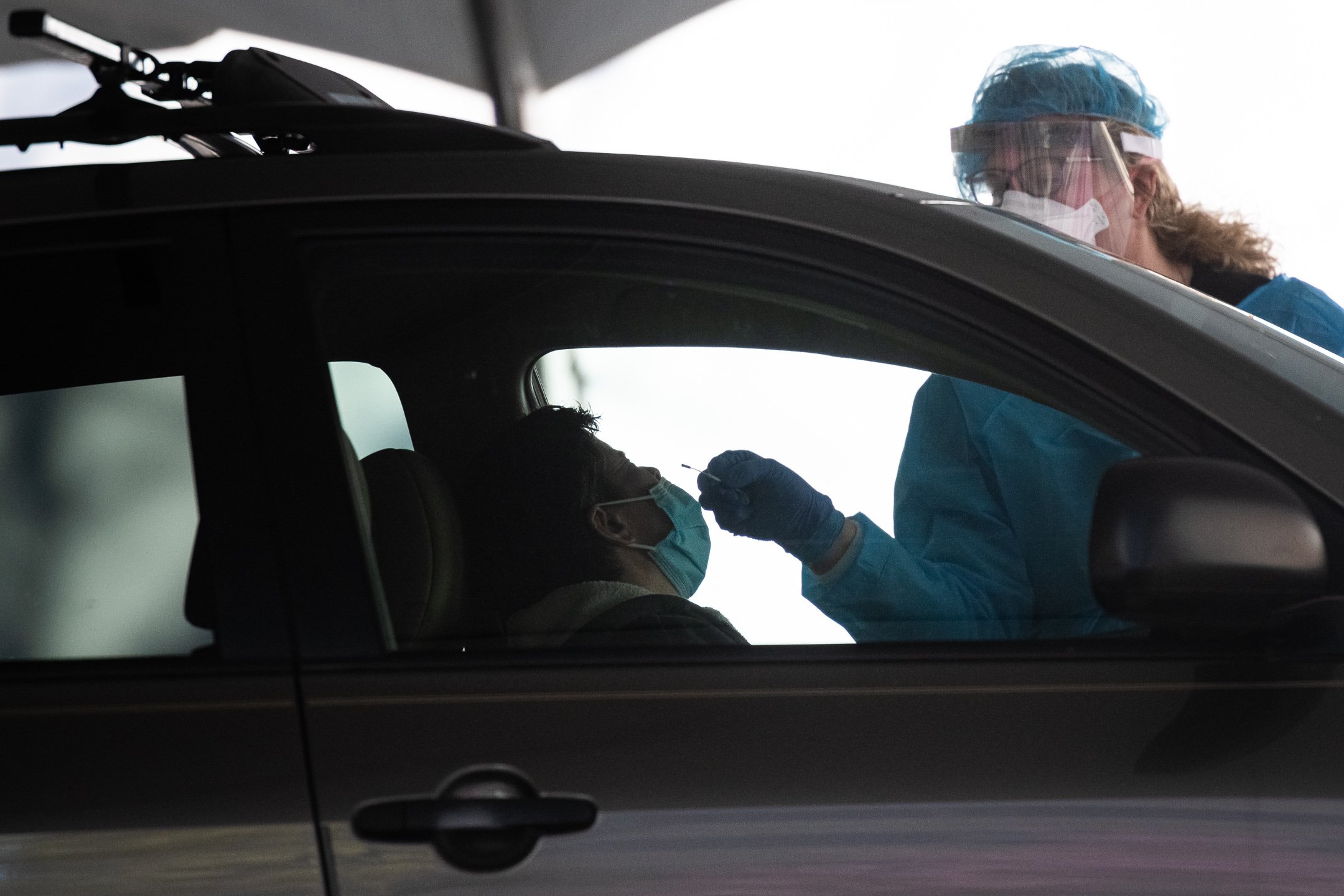  A healthcare worker takes a nasal test swab of an individual at a drive-thru COVID-19 testing facility amid the coronavirus pandemic, at George Washington University, in Washington, D.C., on April 6, 2020. (Graeme Sloan/Sipa USA) 