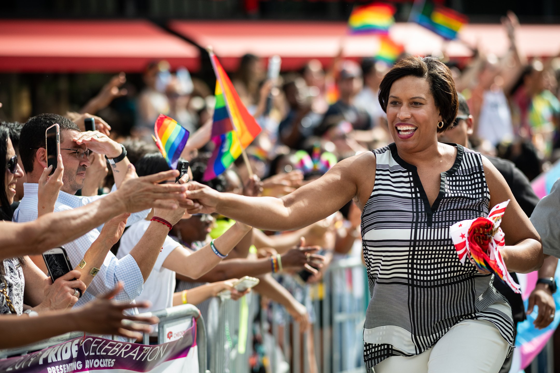  Washington Mayor Muriel Bowser runs along the Capital Pride Parade route with pride flags in hand, near Dupont Circle, in Washington, D.C., on June 8, 2019. (Photo by Graeme Sloan) 