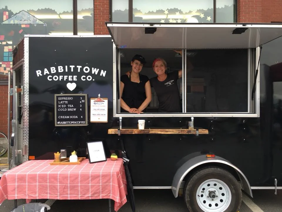 Katie Cunningham (Left) and Stef Loukes set up at the Garrison Night Market
