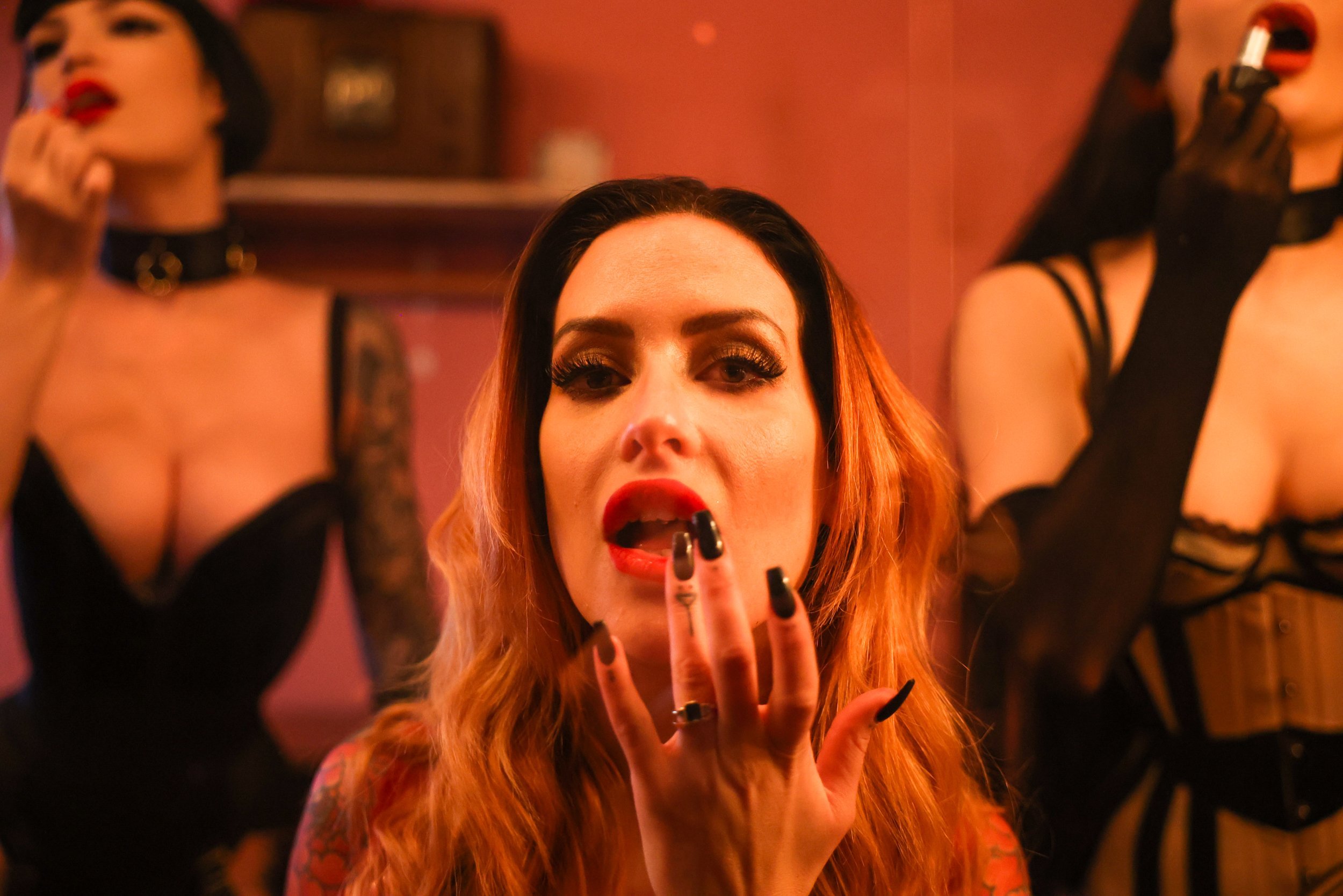  Burlesque performers of the House of Noir prepare themselves - in a two-way mirror - for the immersive experience and “erotic masquerade,”  Nude Noir , on Wednesday, October 12, 2022.   The two night, invitation-only event boasts an international ca