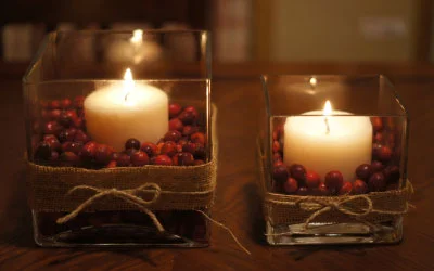 Fill glass vases and votives with cranberries and candles. Courtesy: Lady's Little Loves