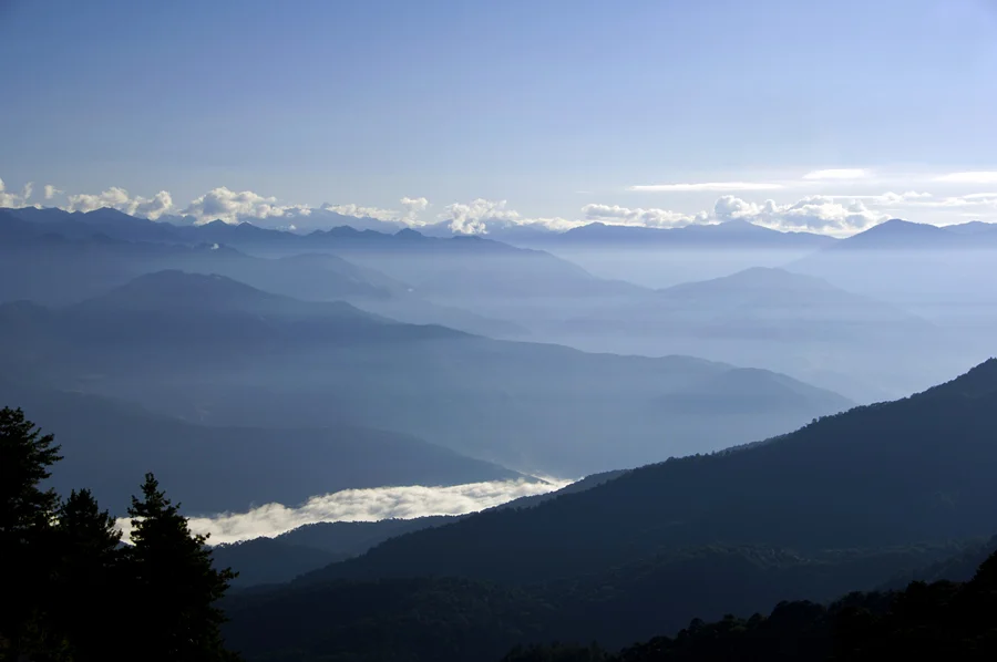 Bhutan is located in Central Asia, bordered in the west by Nepal, the south and southeast by India, and the north by Tibet and the Himalayas. An early morning stop at Dochu La Pass provided this view of the snow-capped Himalayan Mountains.