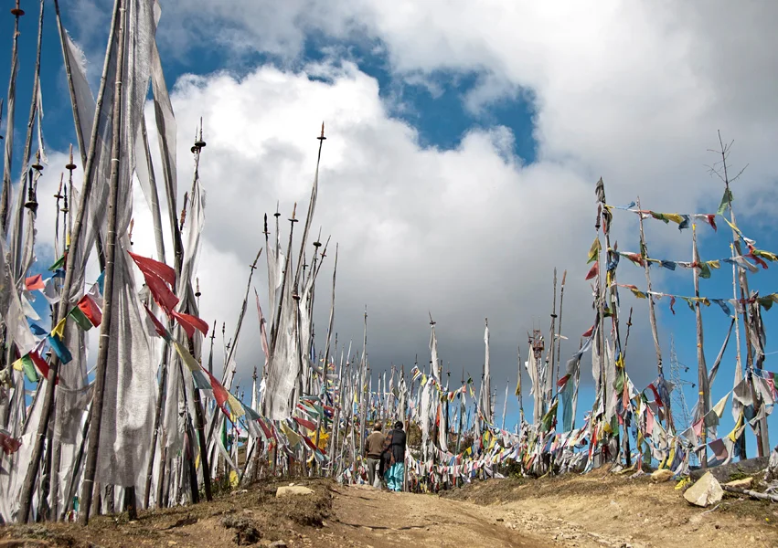 Prayer flags flutter throughout Bhutan. These prayer flags line the climb to the top of Cheli La Pass where a view of the snow-capped Himalayan Mountains is possible and, if luck holds, Jomolhari, Bhutan’s 2nd highest mountain.