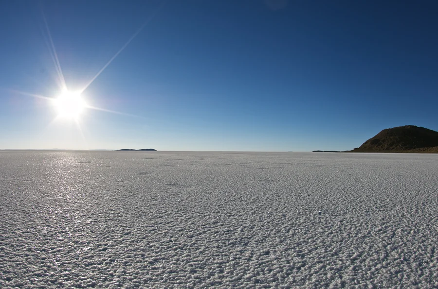 Salar de Uyuni at sunrise looks like a never-ending expanse of sparkling diamonds.