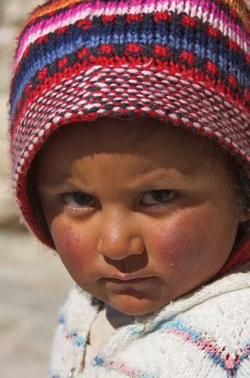 A portrait of a Bolivian child who lives at Isla Incahuasi with her family.