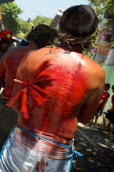 Their backs weeping blood, flagellants trudge through the streets under the blazing sun asking for the forgiveness of sins committed; the strength to fulfill pledges made (panada); or giving thanks to God for illnesses or injuries cured.