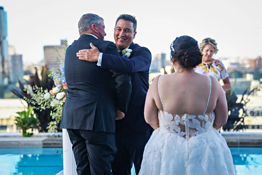 Brisbane Celebrant_Lina Rooftop ceremony father groom hug