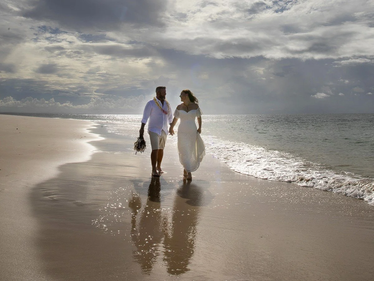 Couple walking on beach after their wedding with Trudy the Brisbane celebrant