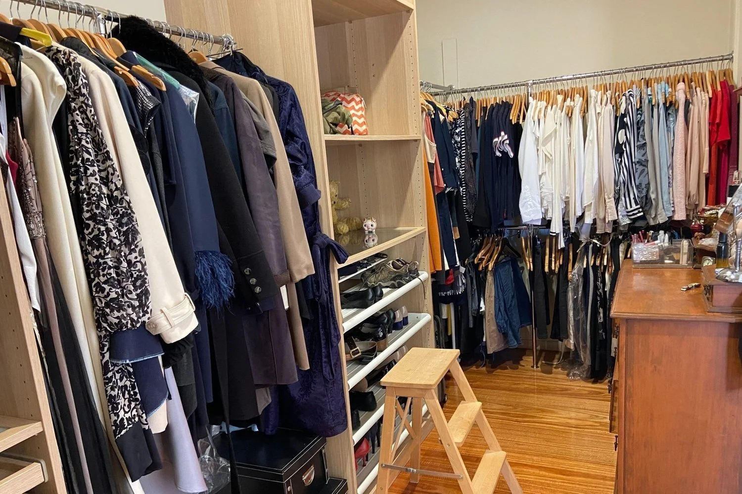 Open wardrobe shelves and hanging clothes during a wardrobe audit at home