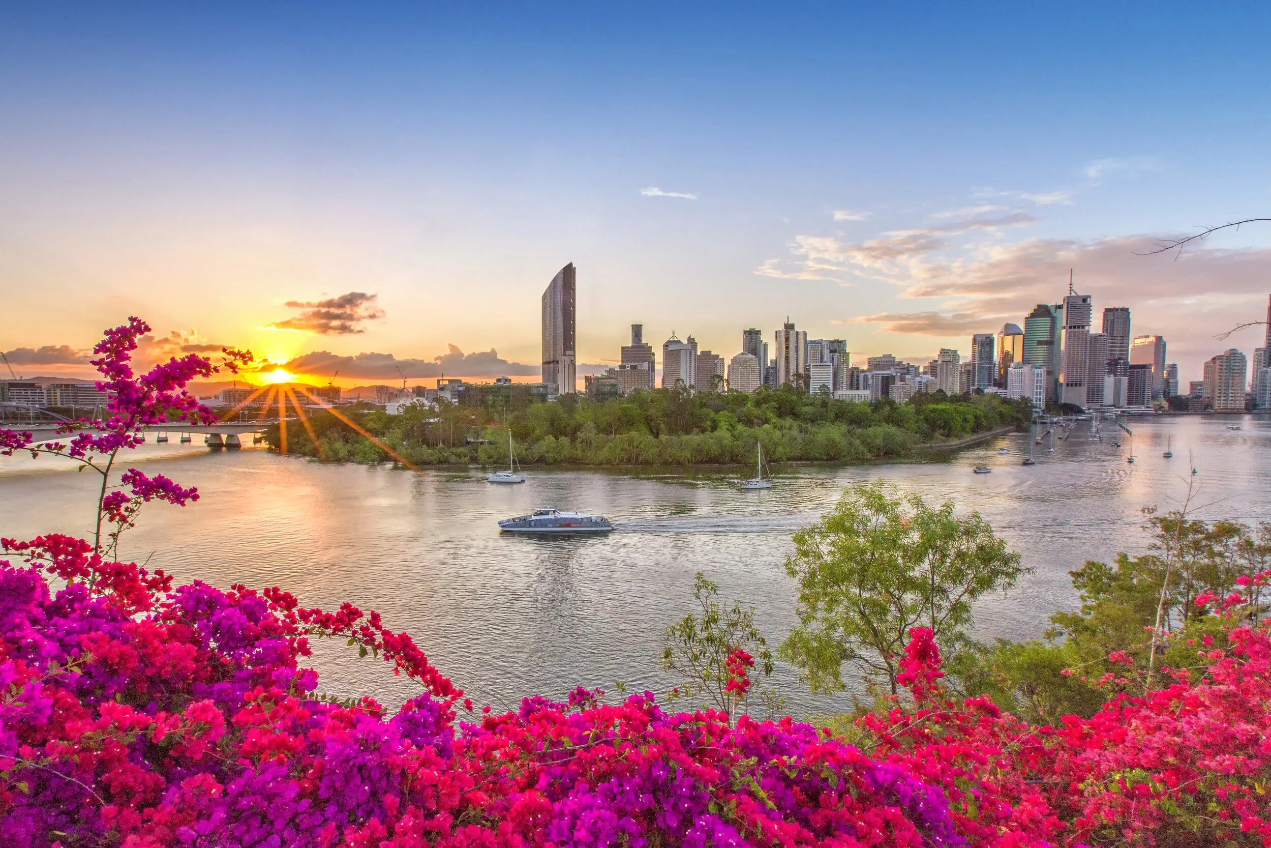 Brisbane city skyline and the Brisbane River at sunset