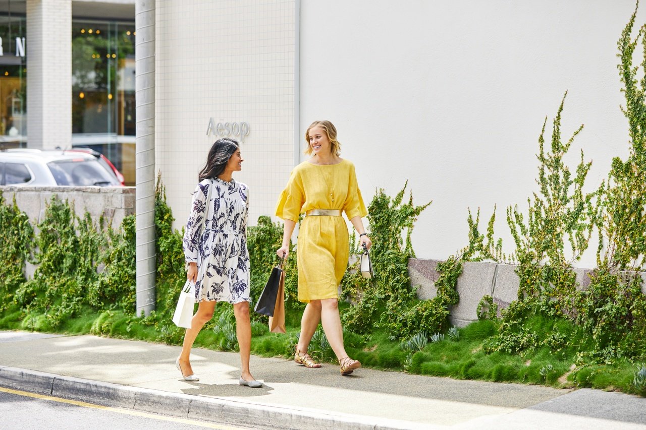 Two women in dress talking and walking past Aesop store in James Street_Fortitude Valley.jpg