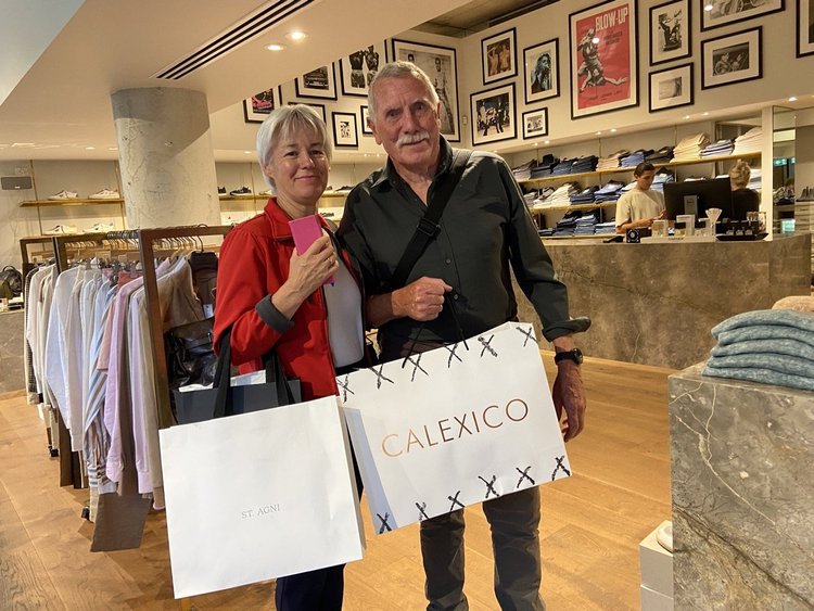 Happy shoppers with their bags after a menswear styling session