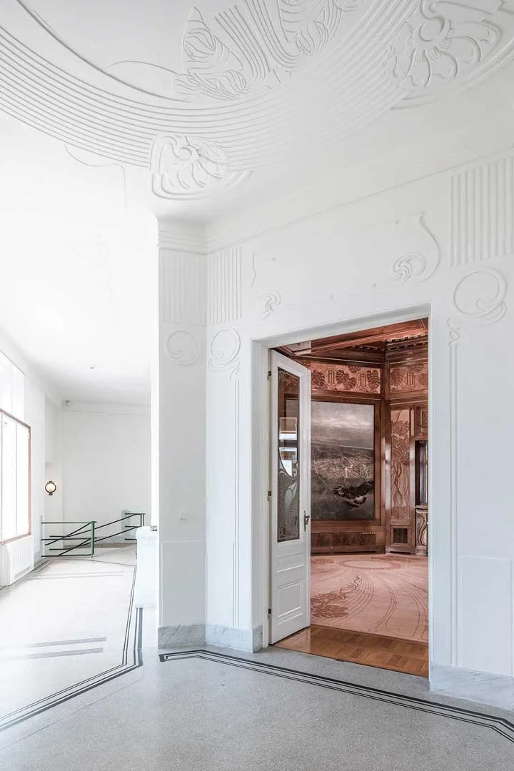 Interior shot of Emperor Franz Josef's private train station in Hietzing, Vienna — white hallway with stunning Art Nouveau ceiling relief