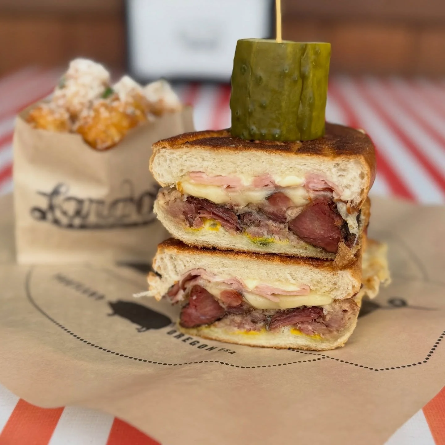 This is what&rsquo;s for lunch! Smokey Cubano: smoked mojo pork shoulder, shaved ham, Swiss cheese, sweet
pickles, yellow mustard, and mayo! Come and get it, we open at noon. Pair it with some elote tots or dirty fries and call it the PERFECT MONDAY.