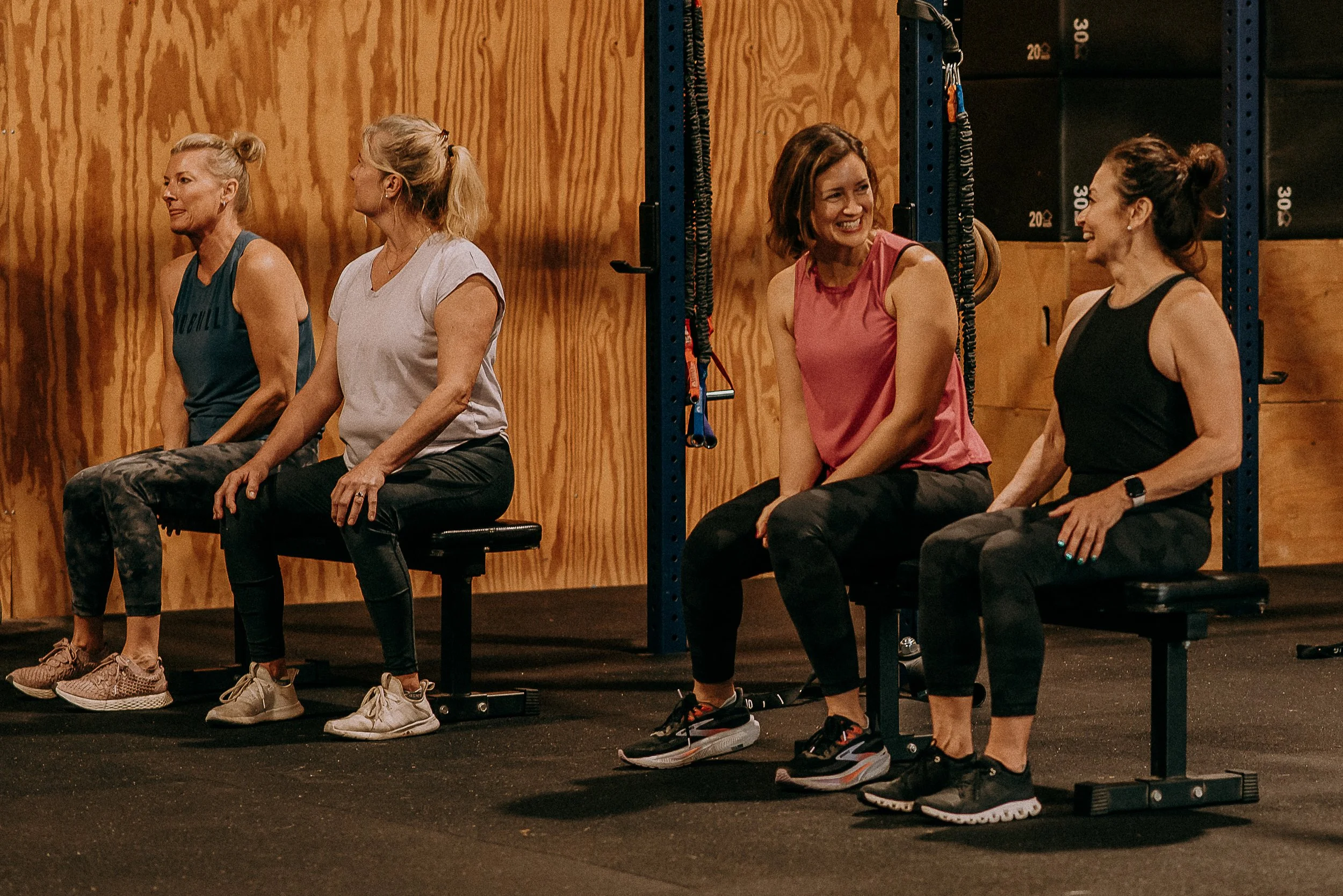 Small group training members share laughs between sets.