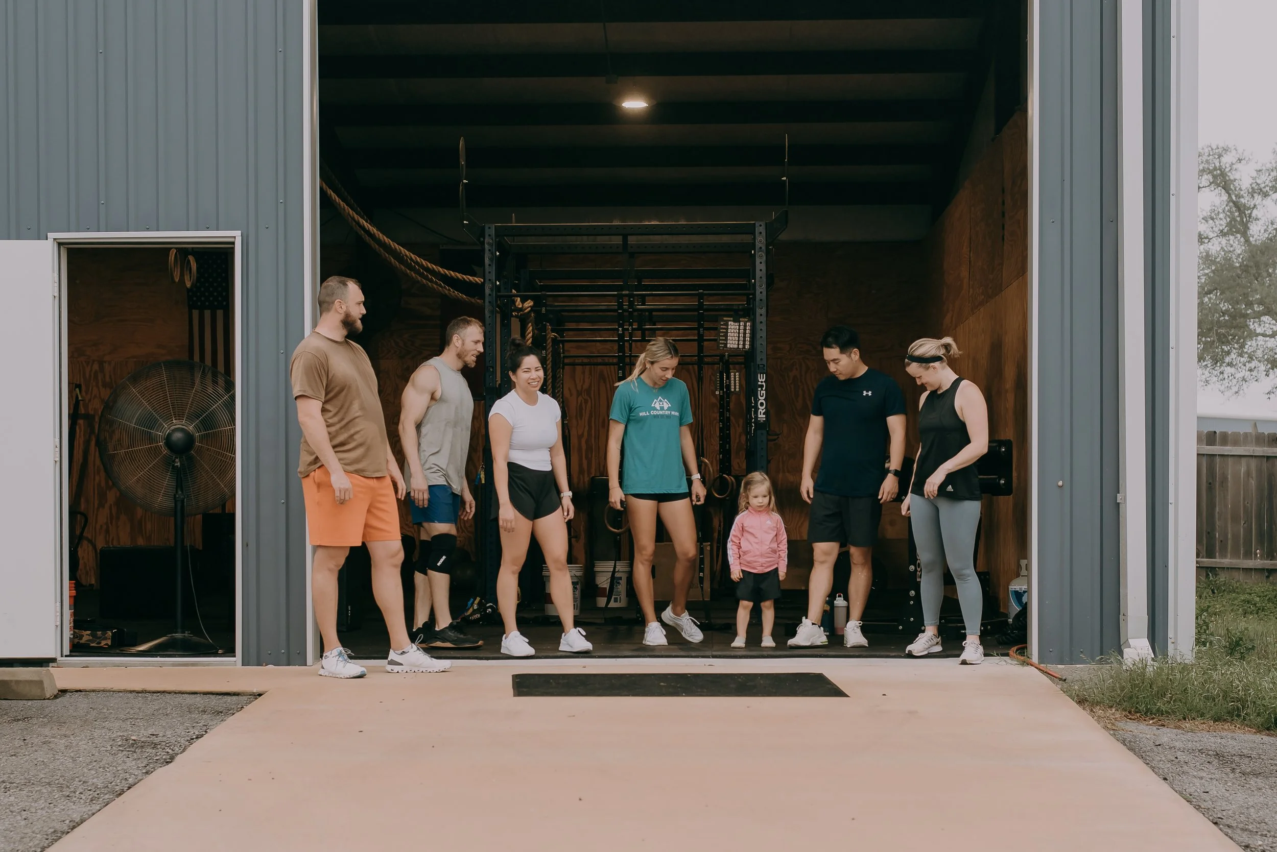Small group training members get ready to run with a young athlete at the gym.
