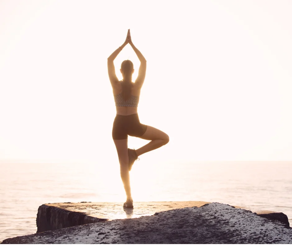 Woman practicing yoga for self care.