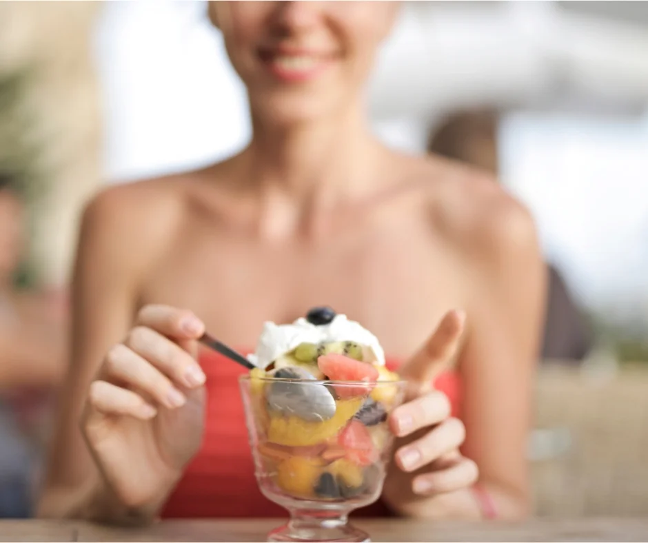 Woman eating fresh fruit.