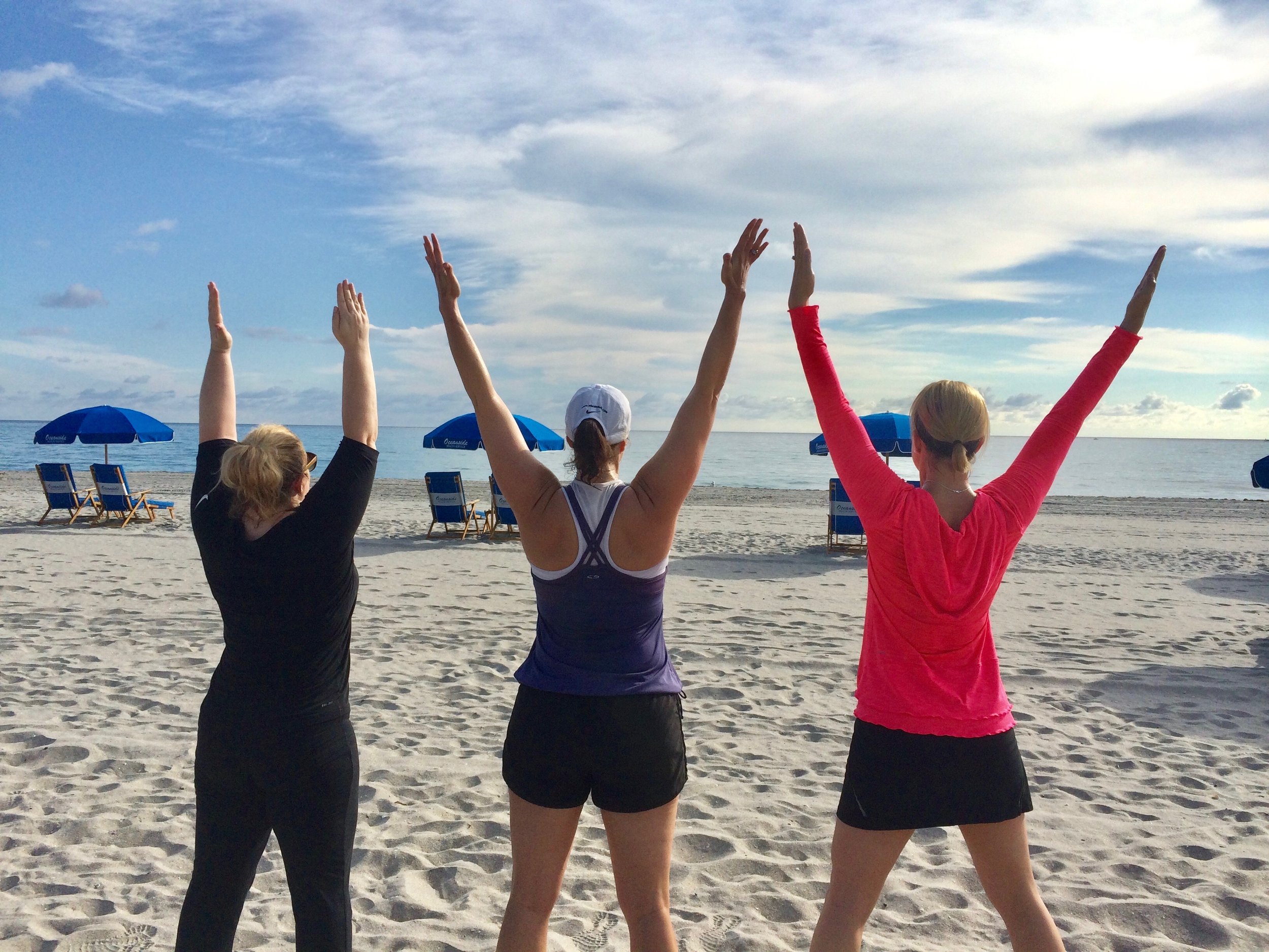 Clients celebrate their retreat with arms in the air.