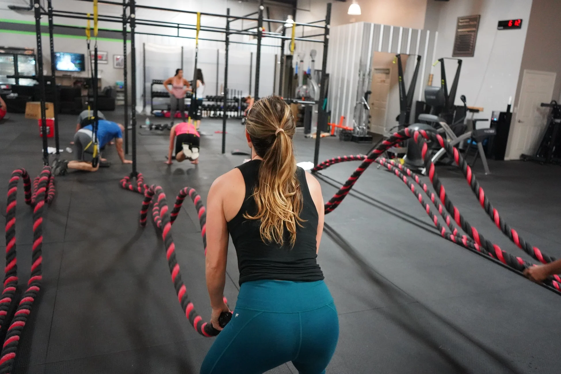 Girl trying ropes to improve her fitness level.